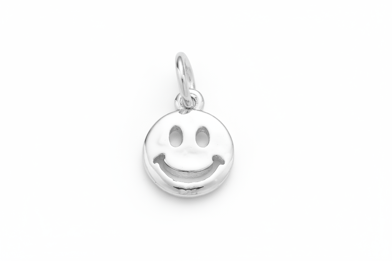 Silver smiley face pendant on a gray background