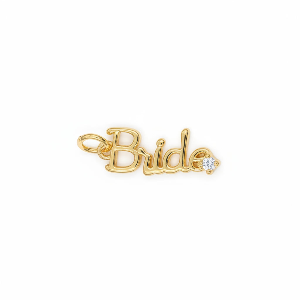 A gold script charm spelling 'Bride' with a small clear gemstone accent, shown on a light blue background.