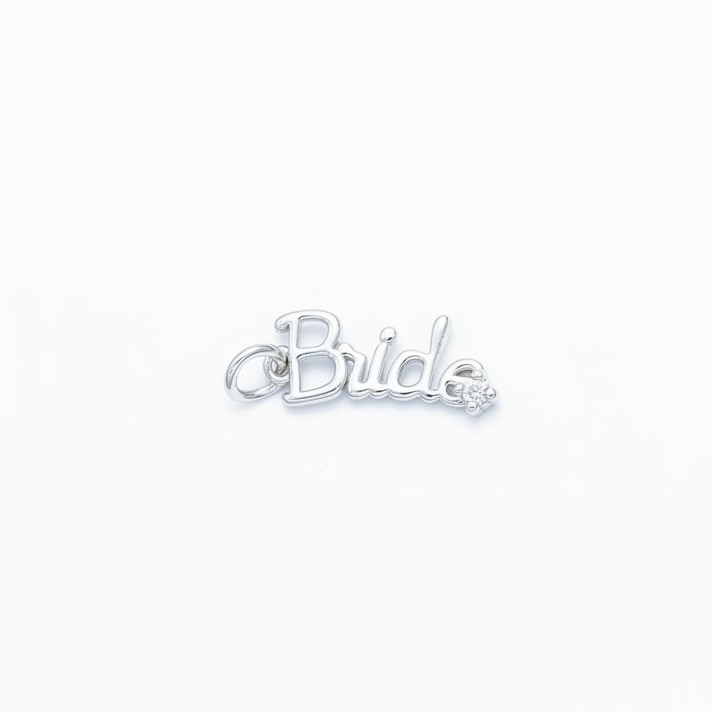 A silver script charm spelling 'Bride' with a small car accent, shown on a light blue background.