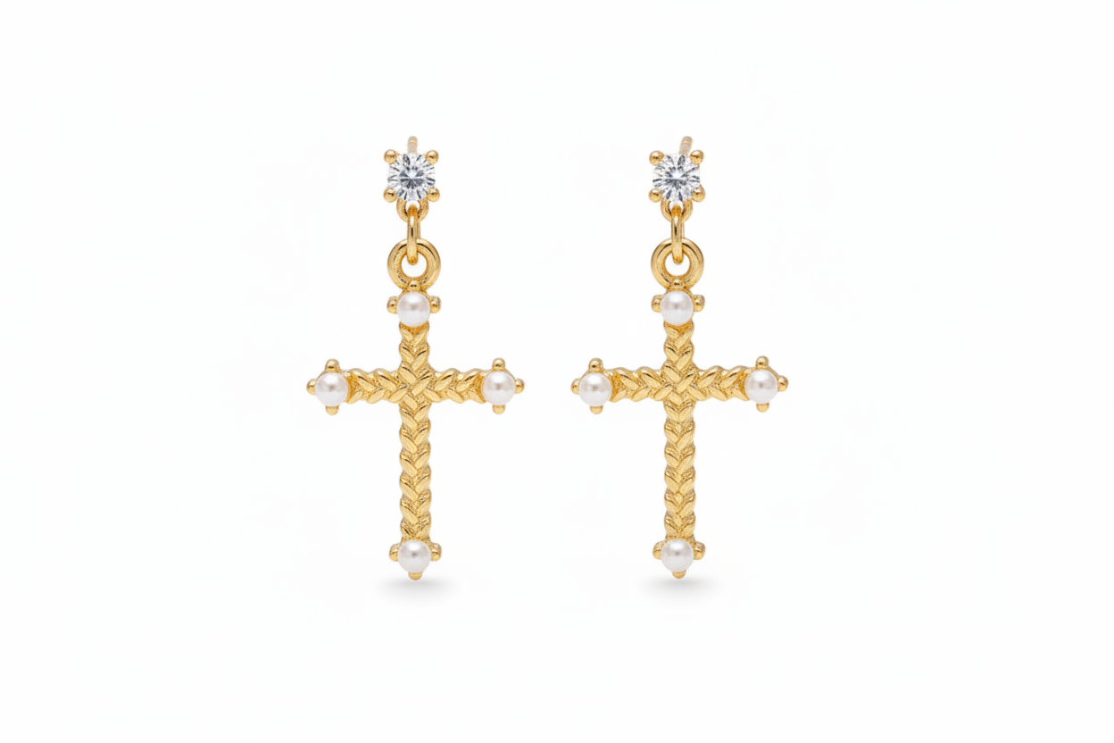 Gold cross earrings with pearl accents on a white background