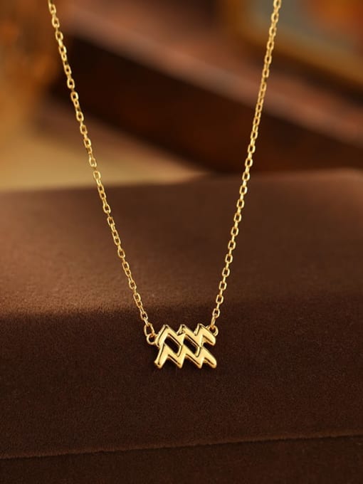 Gold necklace with a unique pendant on a brown surface