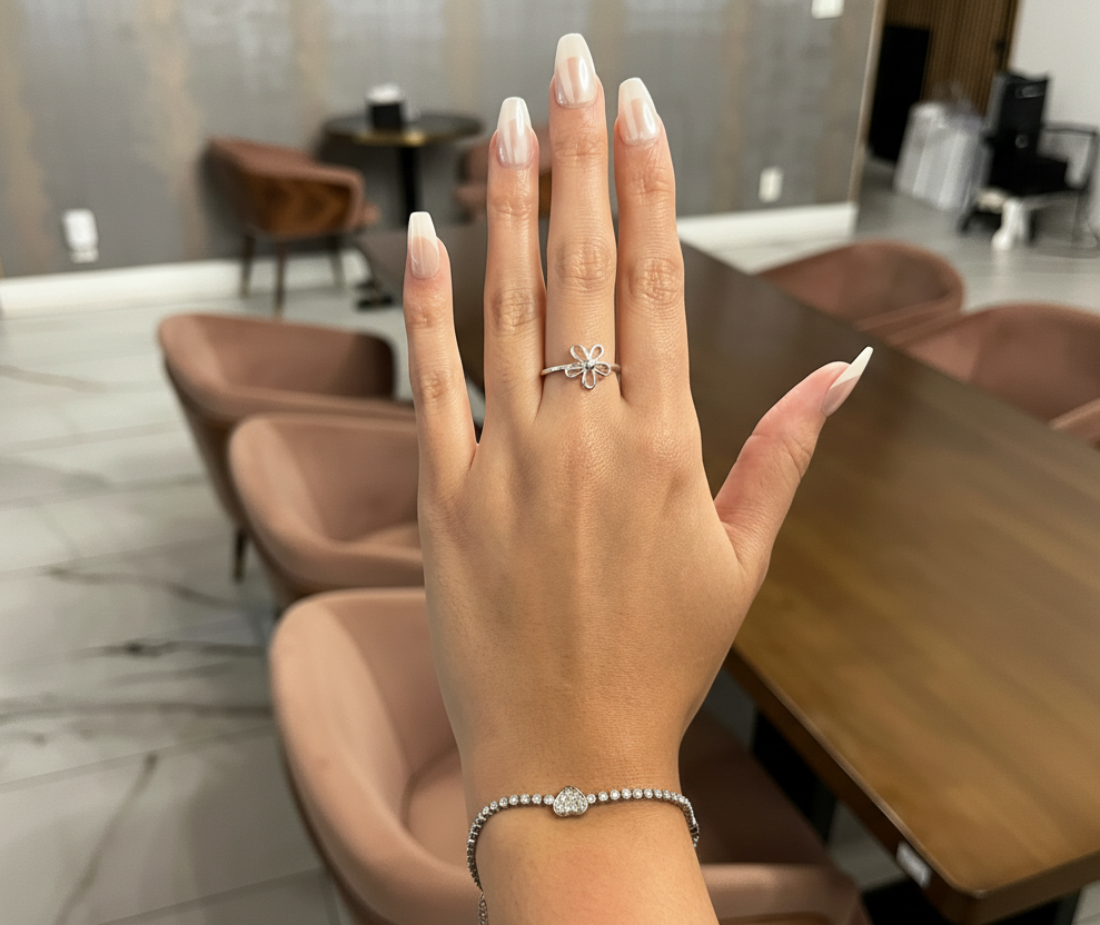 Hand wearing a ring with a blurred indoor setting