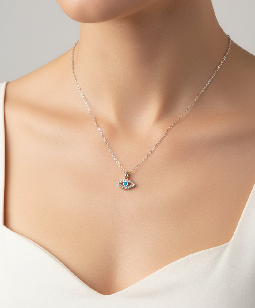 Silver necklace with an eye-shaped pendant on a light gray background
