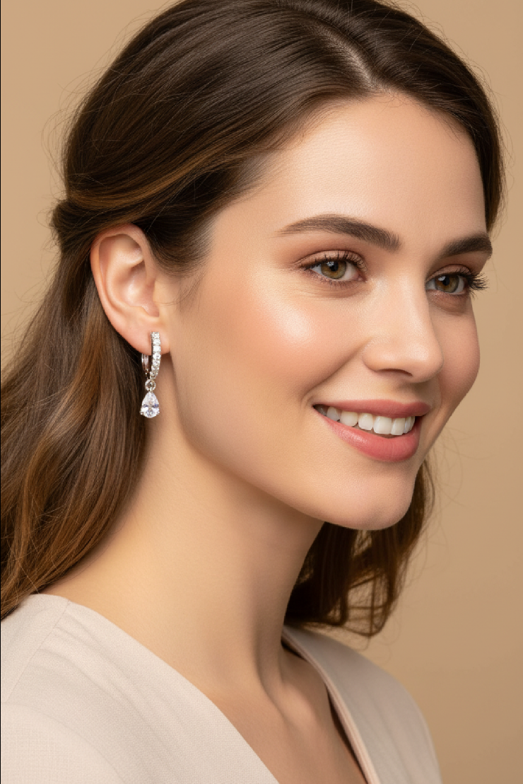 Portrait of a woman with an earring on a beige background.