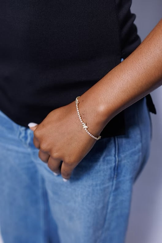 Person wearing a bracelet with a neutral background