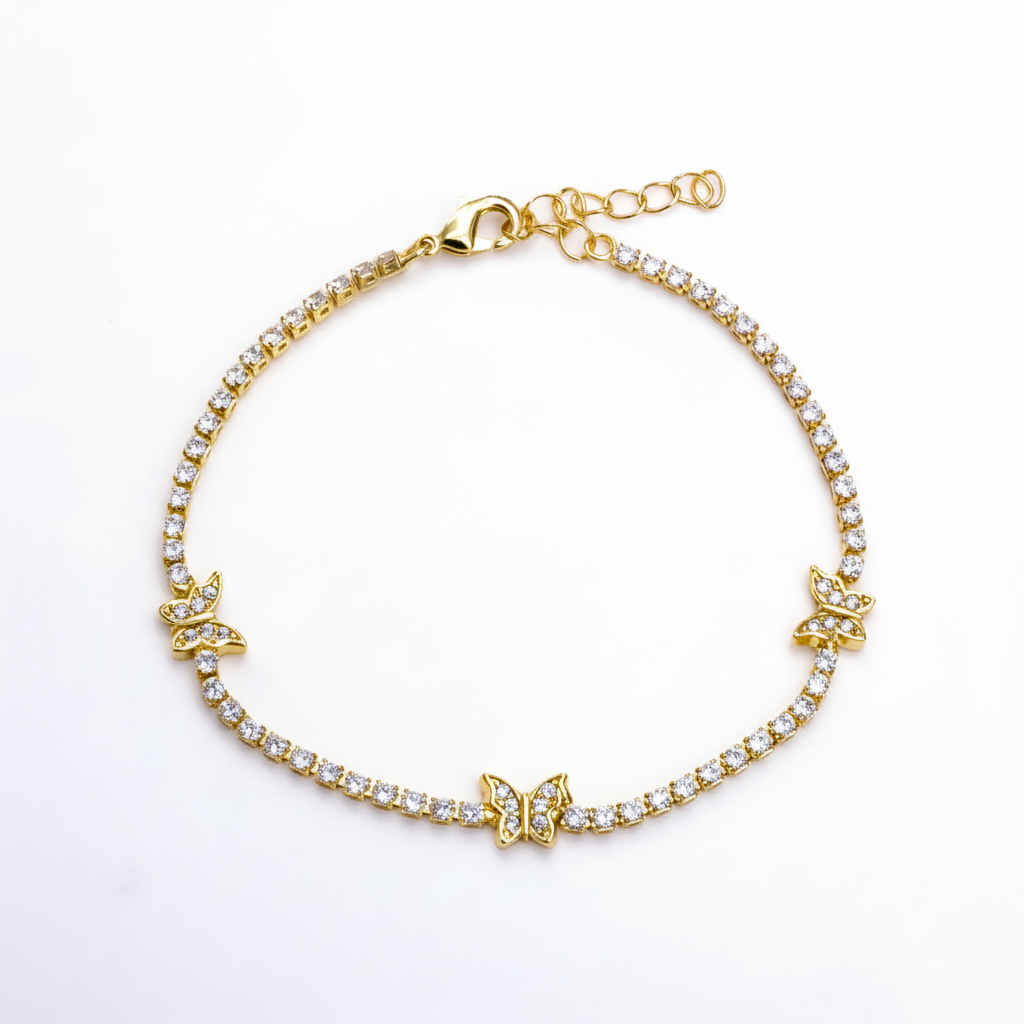 Gold bracelet with butterfly charms on a white background
