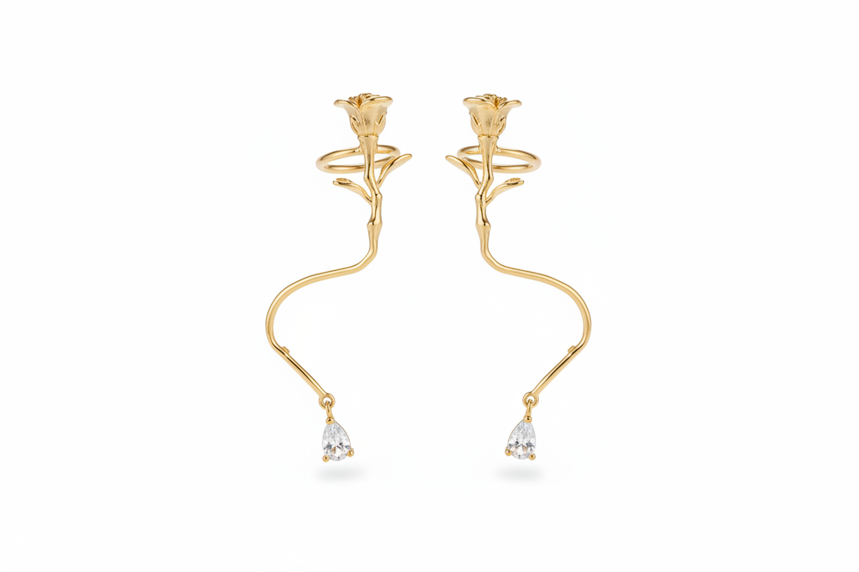 Gold earrings with rose design and teardrop-shaped elements on a white background