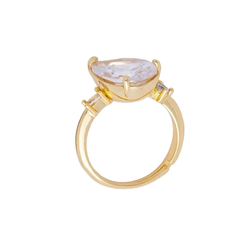 Gold ring with a large gemstone on a white background