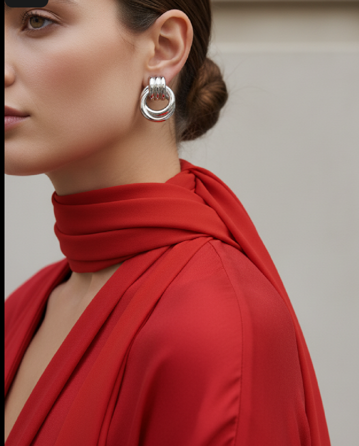 Person wearing a red outfit with a silver earring