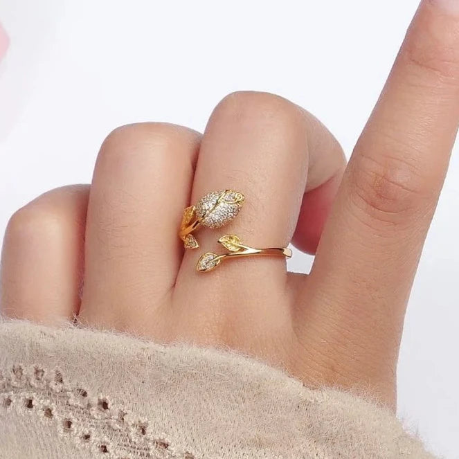 Gold ring on a finger on white background