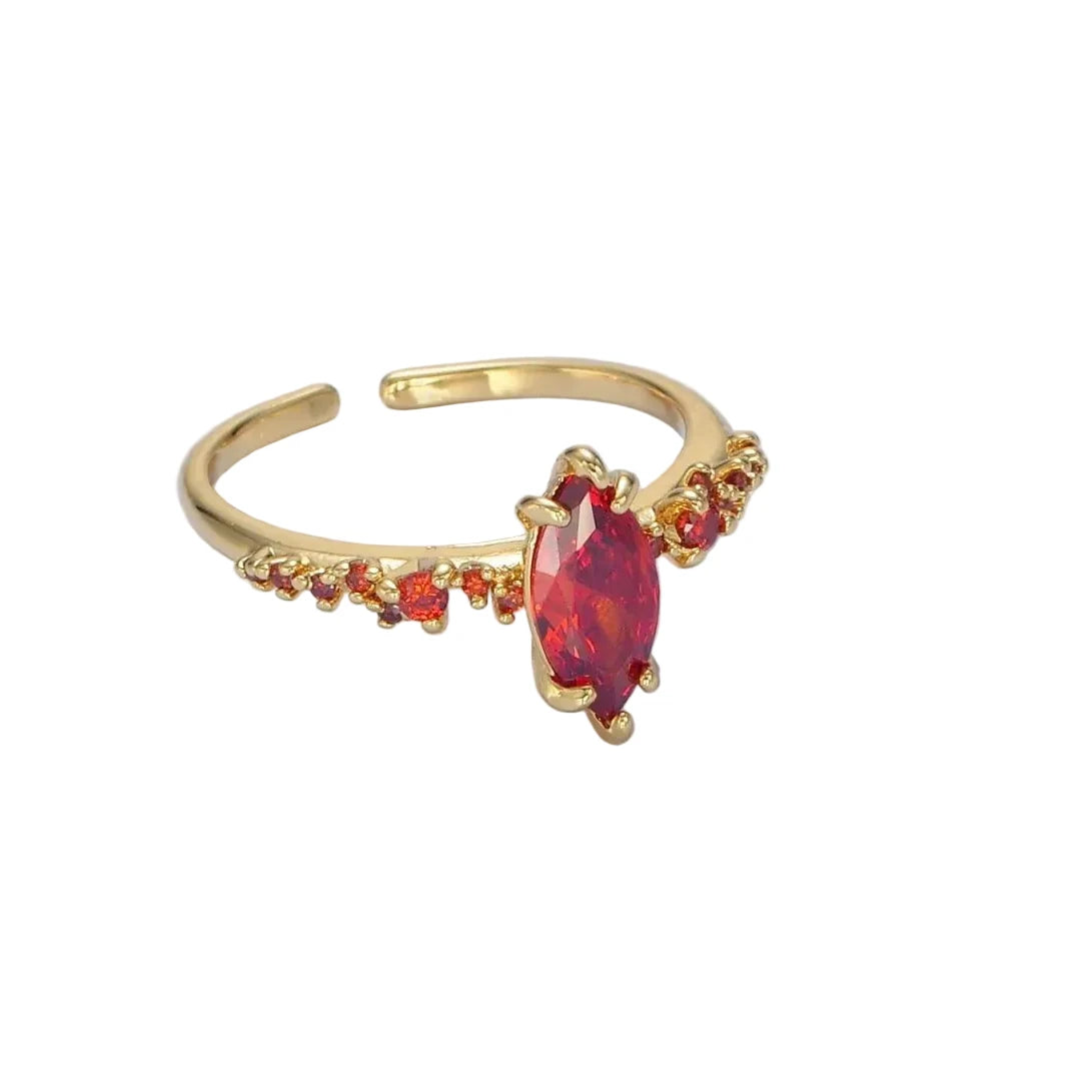 Gold ring with a red gemstone on a white background