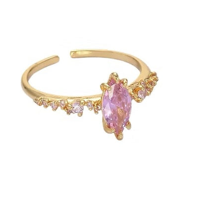 Gold ring with a pink gemstone on a white background