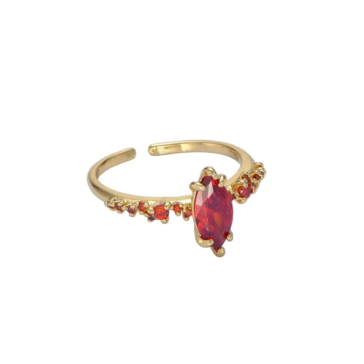 Gold ring with a red gemstone on a white background