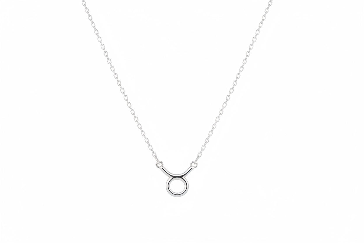 Silver necklace with a small pendant on a white surface
