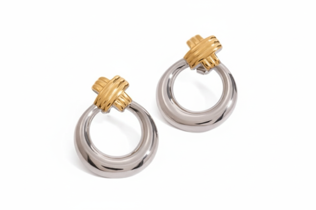 Pair of silver and gold hoop earrings on a white background