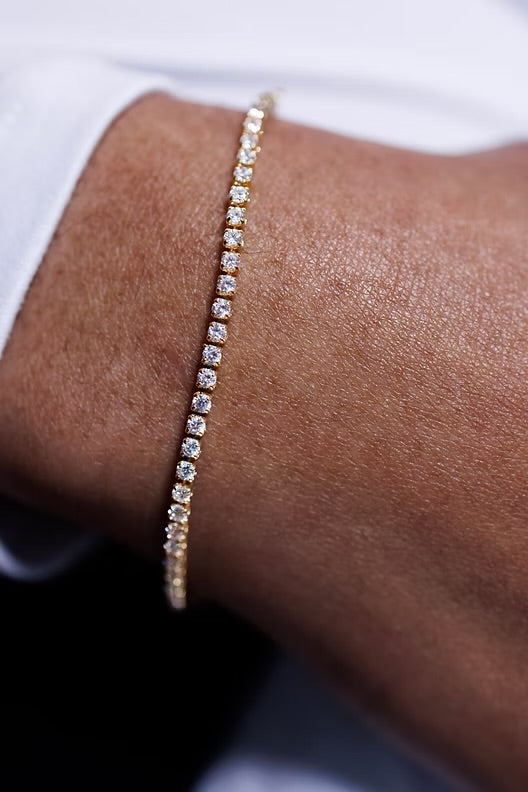 Diamond bracelet on a wrist with a blurred background