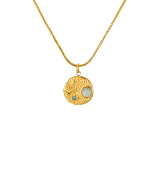 Gold necklace with a round pendant featuring a pearl and gemstone on a white background