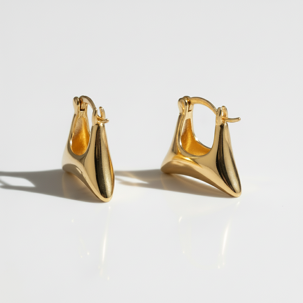 Pair of gold hoop earrings on a light background