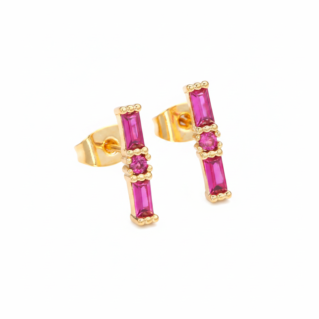 Gold earrings with pink gemstones on a white background
