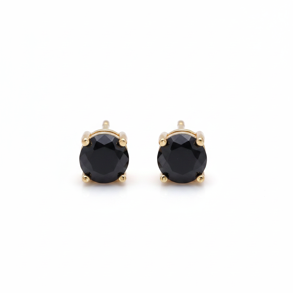 Pair of black gemstone stud earrings with gold posts on a white background