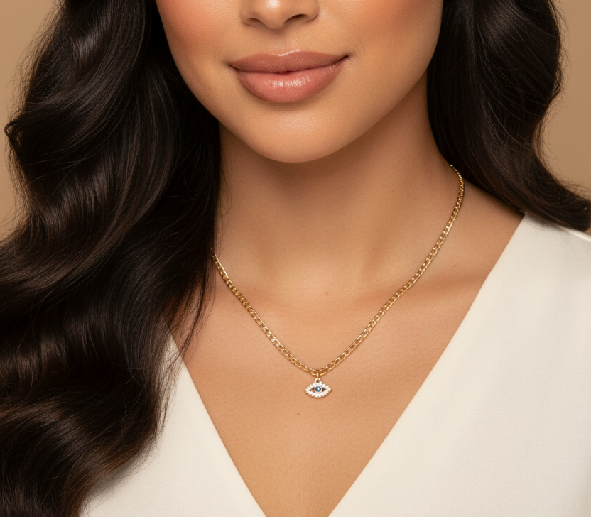 Woman with long wavy hair wearing a gold necklace on a beige background
