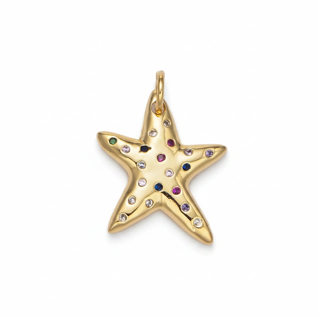 A gold starfish-shaped pendant charm decorated with small, colorful gemstones set into its five points, shown on a clean white background.