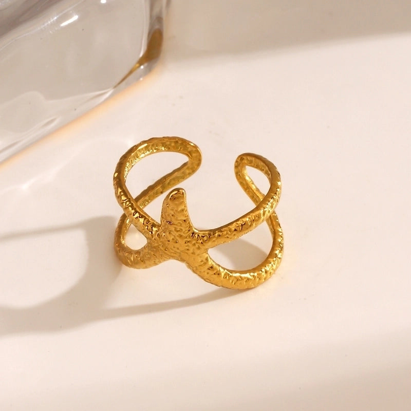Gold ring with a textured design on a light background