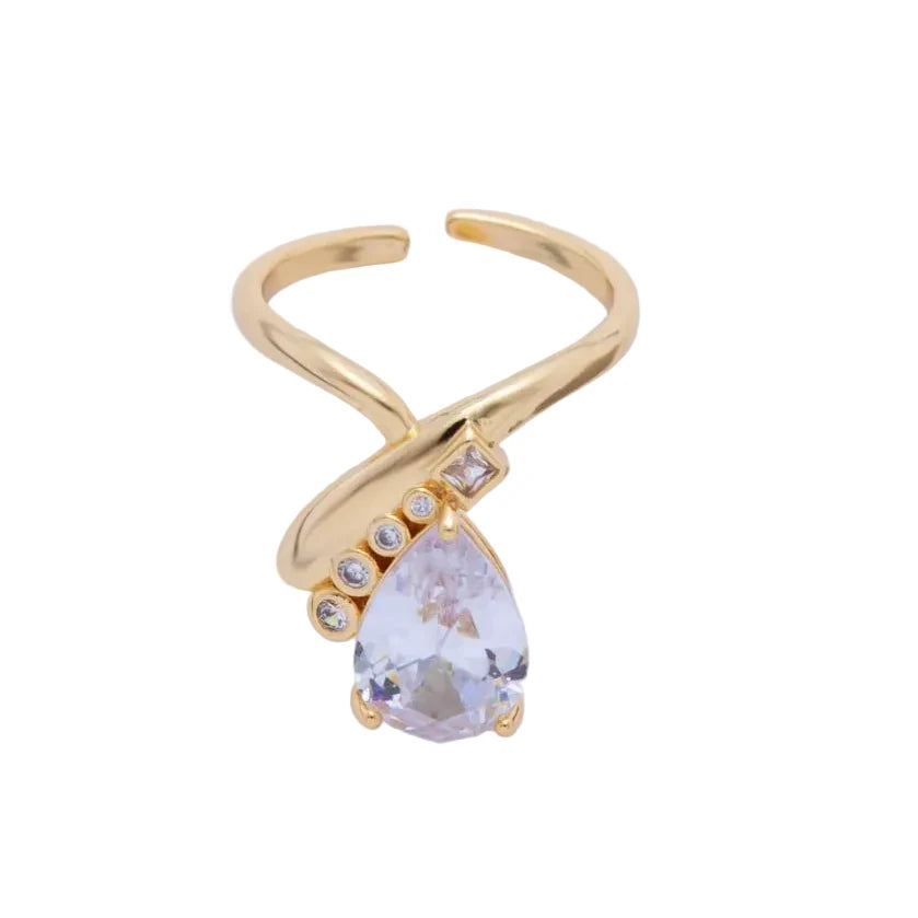 Gold ring with a teardrop-shaped gemstone on a white background