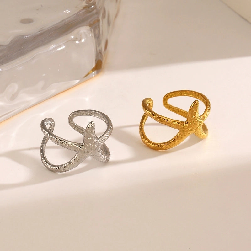 Gold and silver open rings on a light background