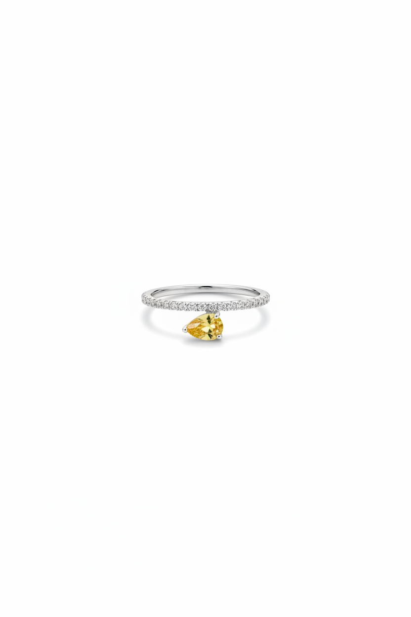 Ring with a yellow gemstone on a white background