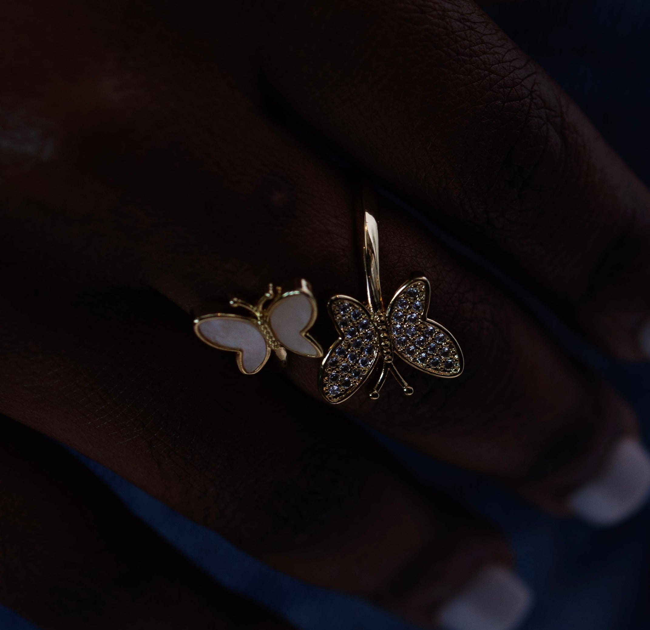 Butterfly-shaped earrings on a dark background