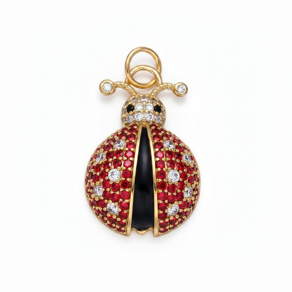 Decorative pendant with red stones, black center, and gold accents on a light purple background
