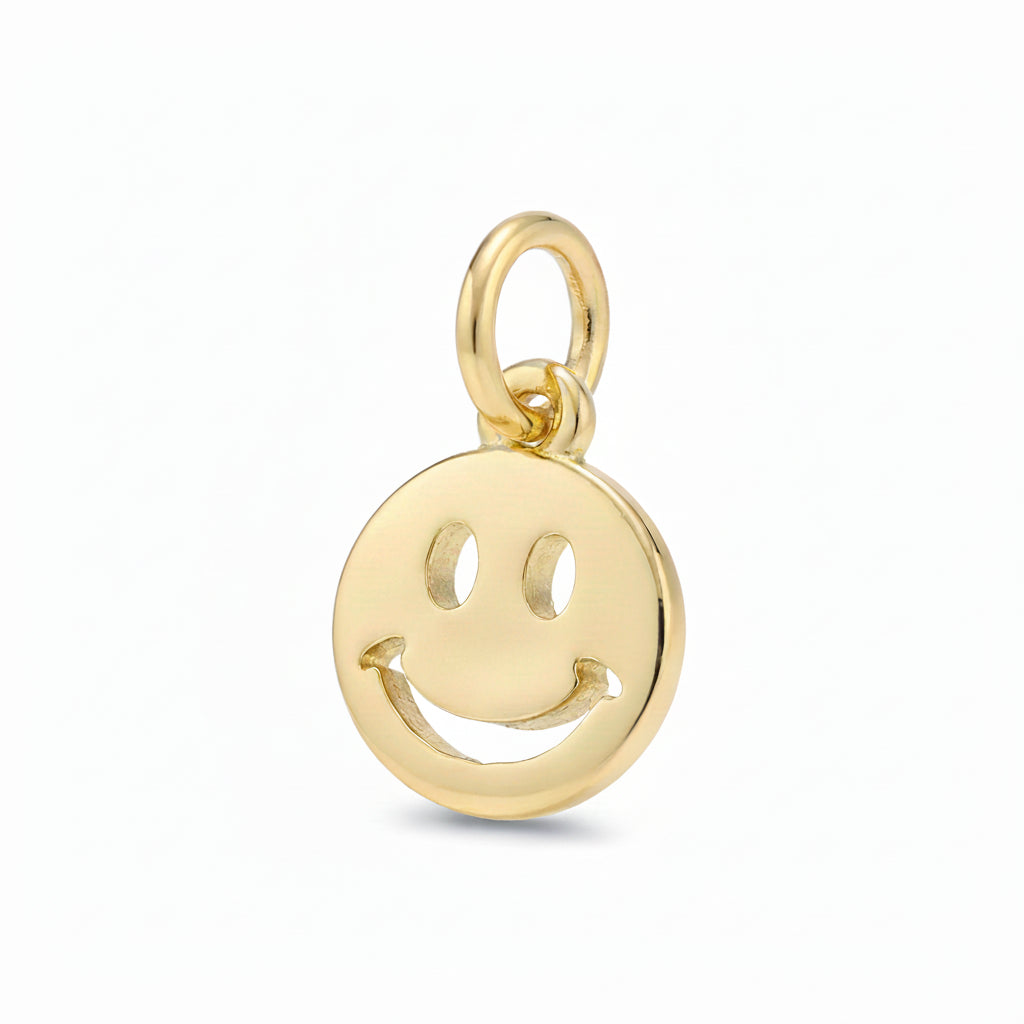 A polished gold smiley face charm pendant with a hanging loop, shown on a clean light gray background.