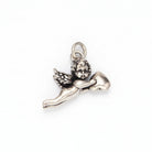 A silver-toned metal cherub pendant charm holding a heart, shown on a plain light background.