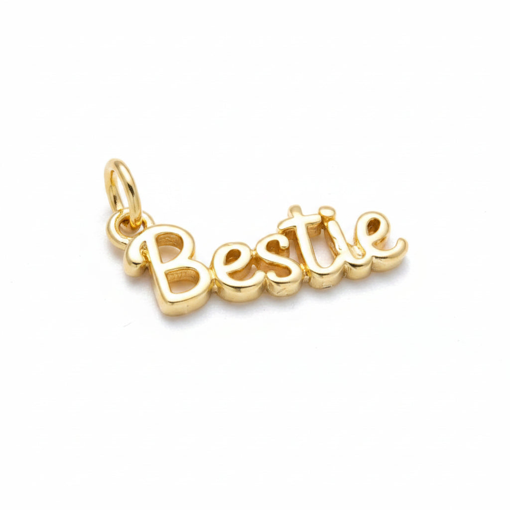 A gold-plated script charm spelling 'Bestie' with a small top loop, shown on a clean white background.