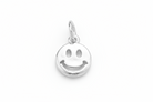 Silver smiley face pendant on a gray background