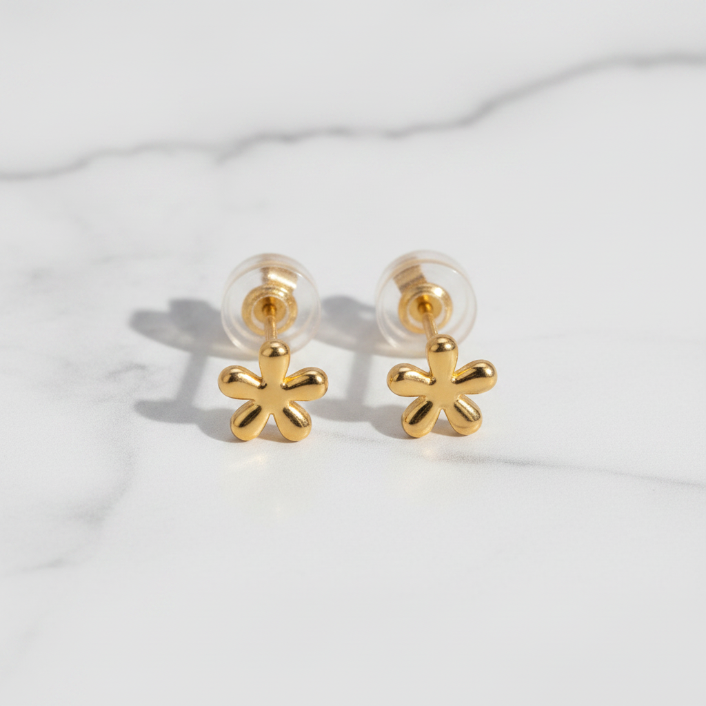 Gold flower-shaped earrings on a white background