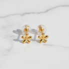 Gold flower-shaped earrings on a white background