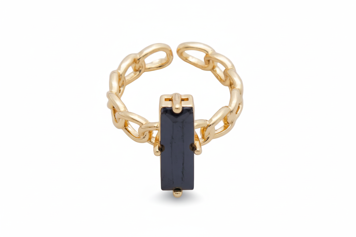 Gold ring with a black gemstone on a white background