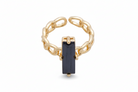 Gold ring with a black gemstone on a white background