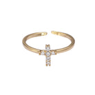Gold open ring with a cross design on a white background