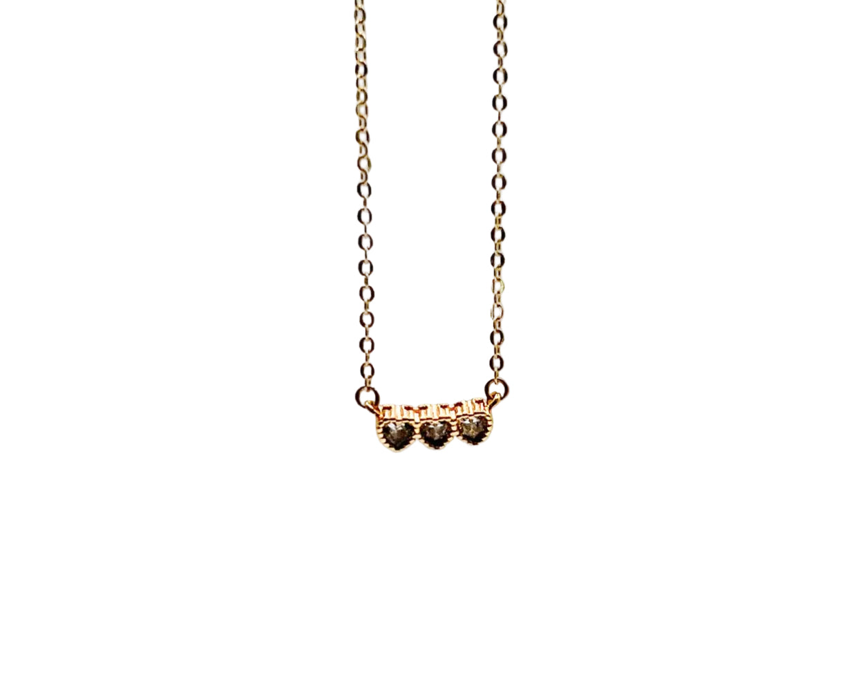 Gold necklace with heart-shaped charms on a white background