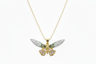 Butterfly pendant necklace on a gold chain against a white background