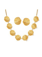 Gold necklace with leaf-like beads on a white background