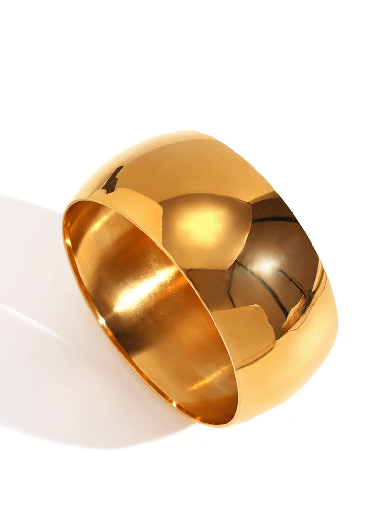 Gold bangle on a white background
