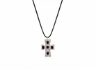 Silver cross pendant with black stones on a black cord against a white background