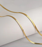 Gold chain on a light gray background