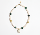 Necklace with pearls and green beads on a white background