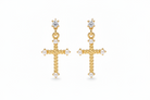 Gold cross earrings with pearl accents on a white background