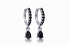 Pair of black teardrop earrings with silver hoop designs on a white background